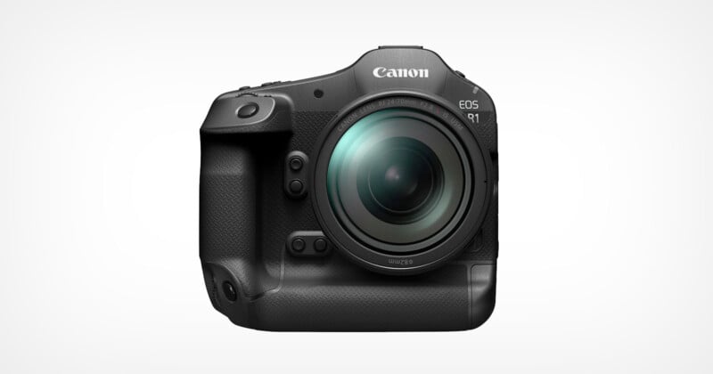 Canon EOS R1 vista frontalmente su uno sfondo bianco.  La fotocamera ha un obiettivo di grandi dimensioni e un'impugnatura strutturata sul lato sinistro, con vari pulsanti e controlli visibili sul corpo.